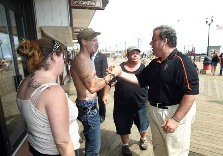 David VanGordon of Toms River tells Governor Chris Christie good job he's doing while walking the boardwalk that didn't sustain fire damage in Seaside Heights